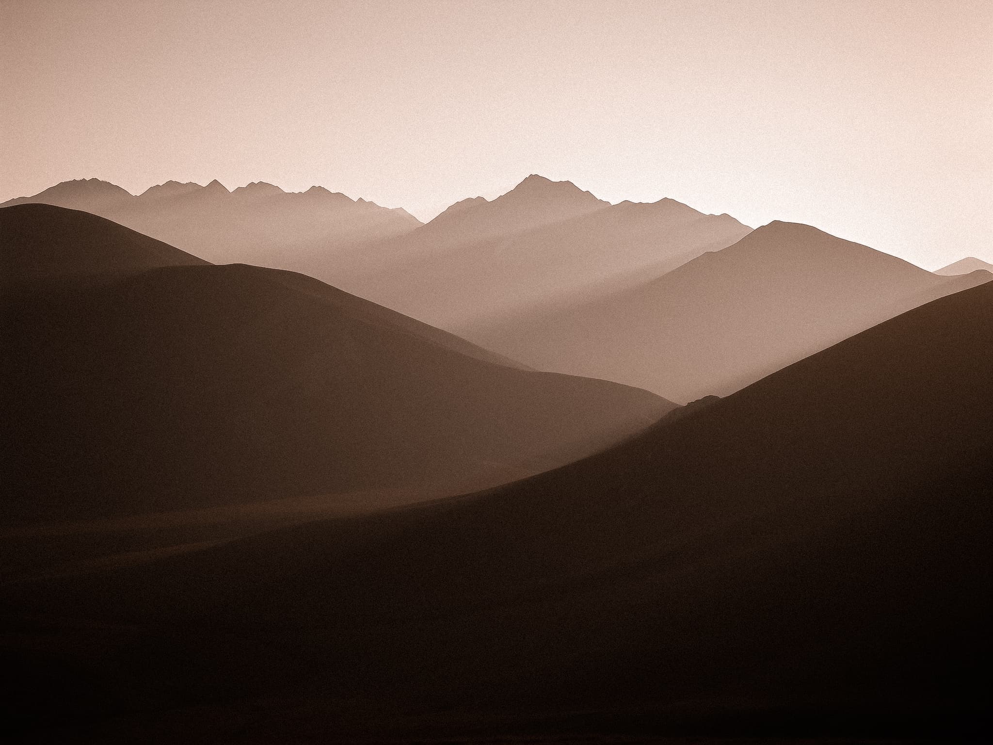 Serene mountain silhouettes at sunset evoking calm transformation