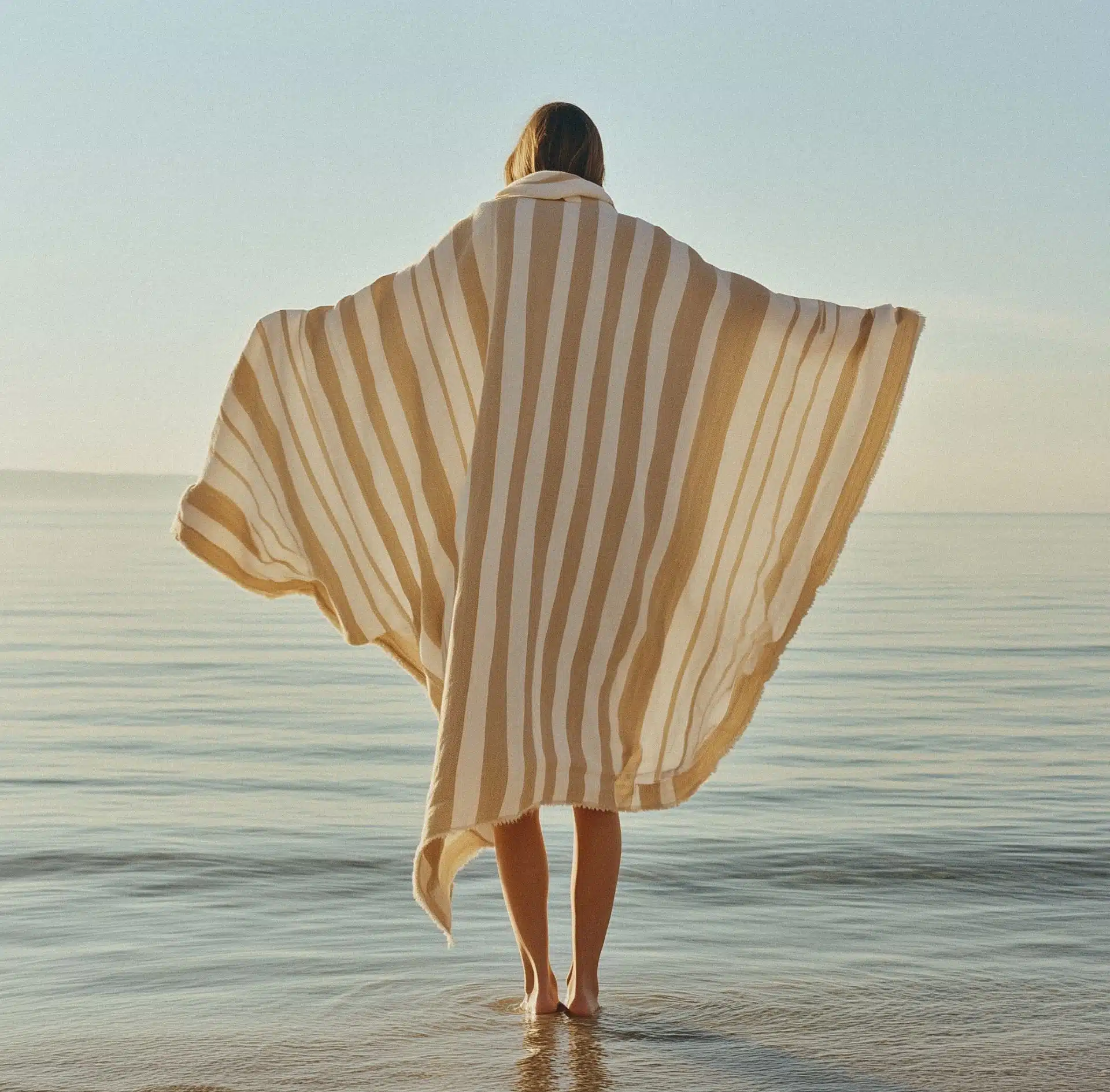 Woman standing peacefully at the Edmonds waterfront with flowing fabric