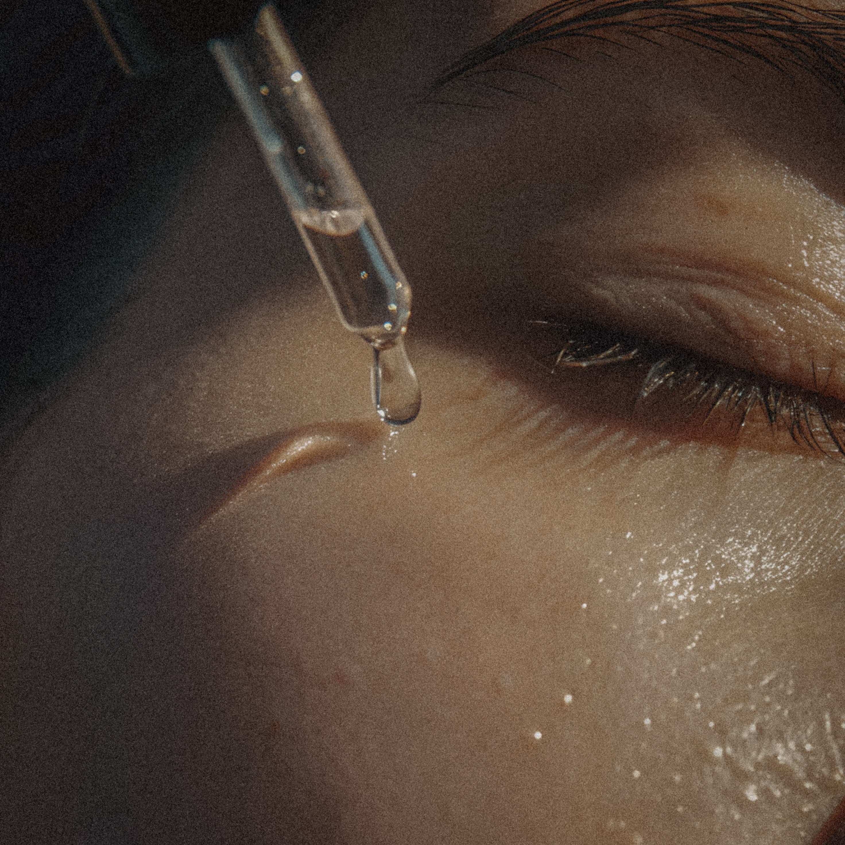 Serum drop on skin, representing precise skincare